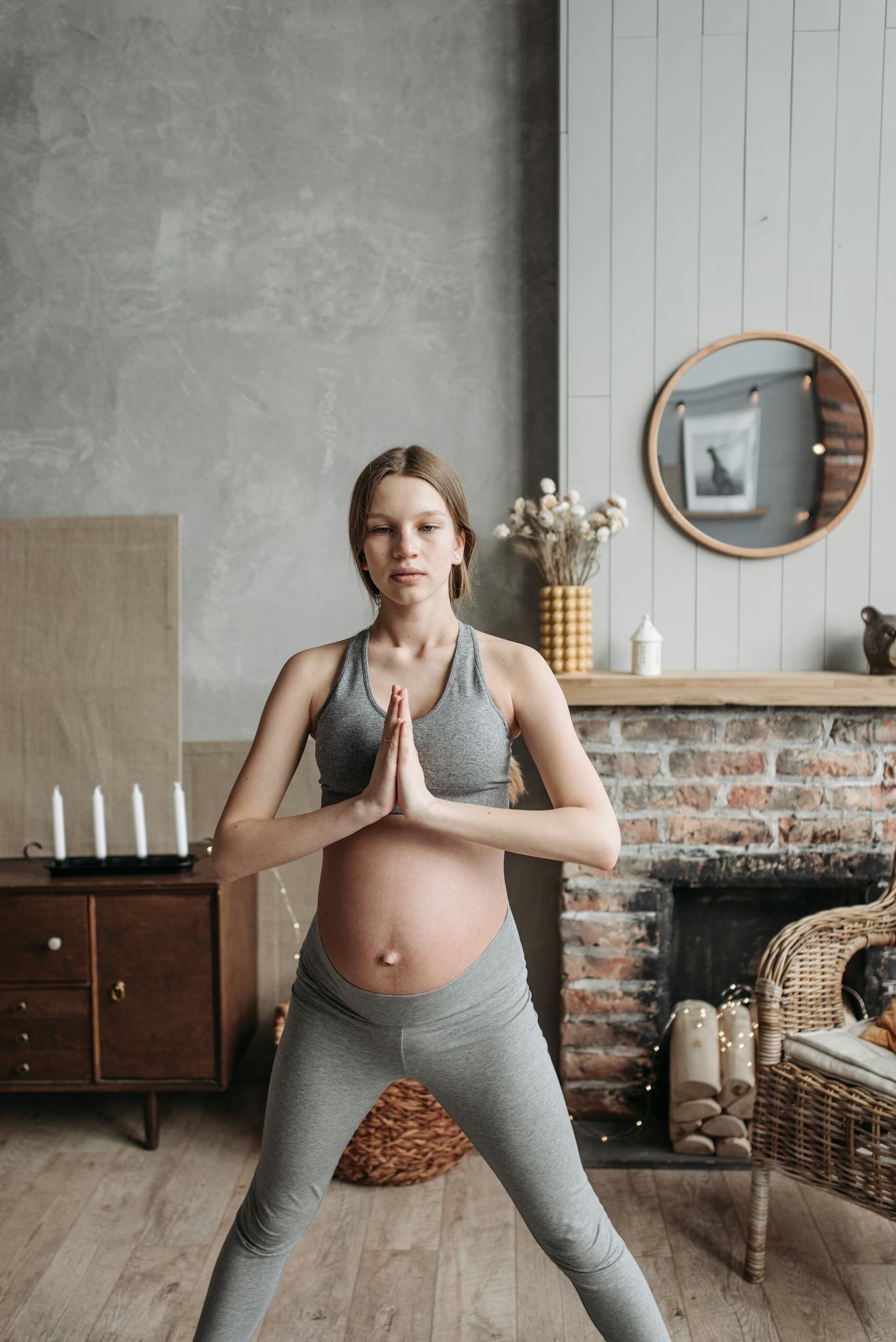 Expectant mother practicing yoga indoors, focusing on pregnancy care and healthy lifestyle.